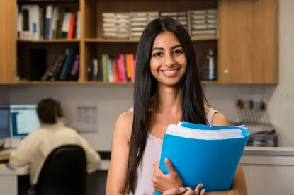 legal expert smiling holding a folder full of documents