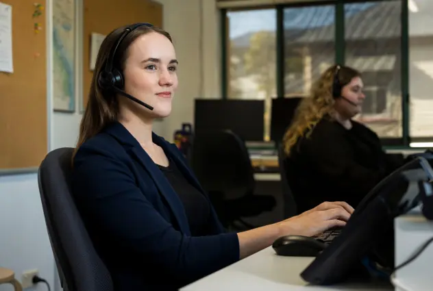 Smiling woman wearing a headset in an office