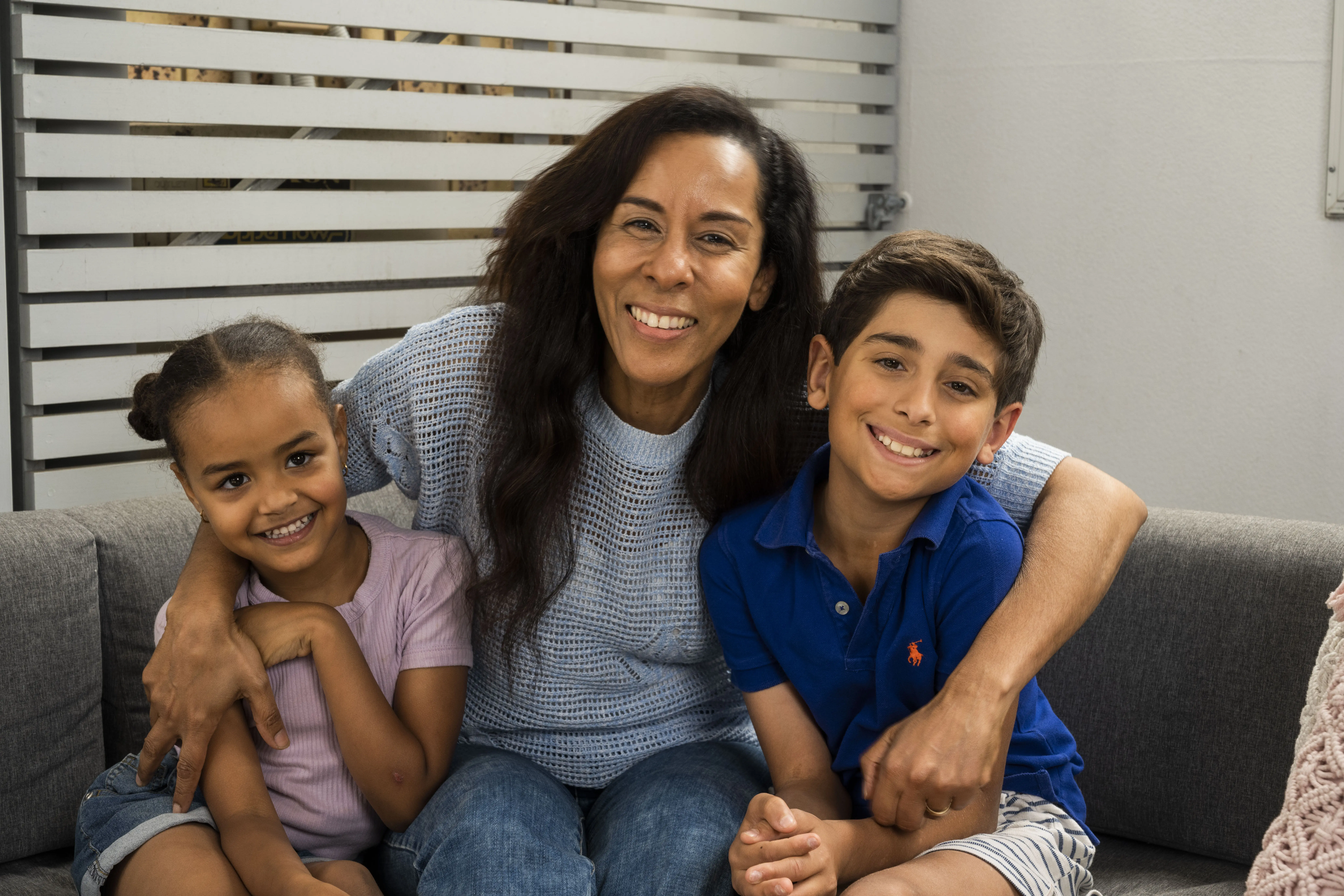 Smiling woman with two young children